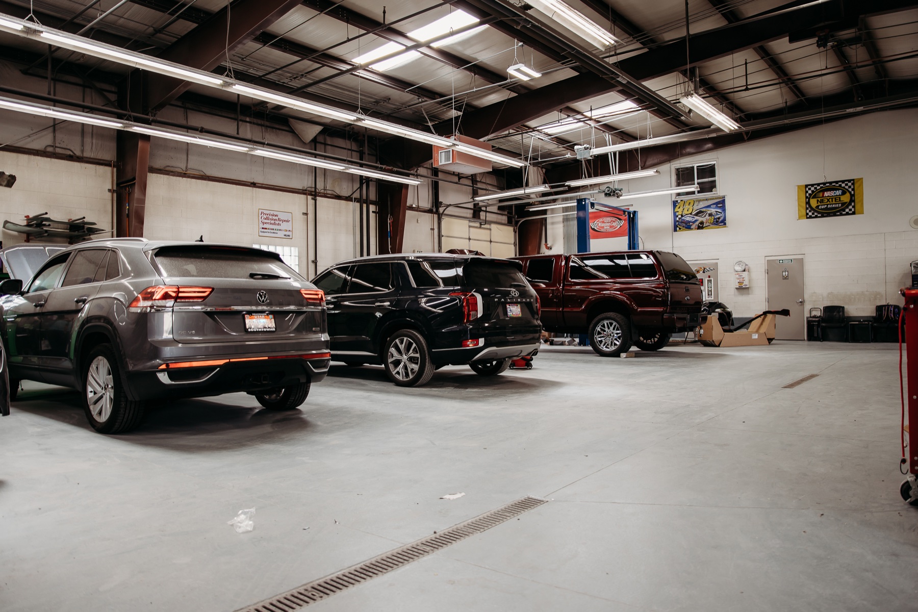 Wide view of the Crazy Color shop floor with vehicles in progress