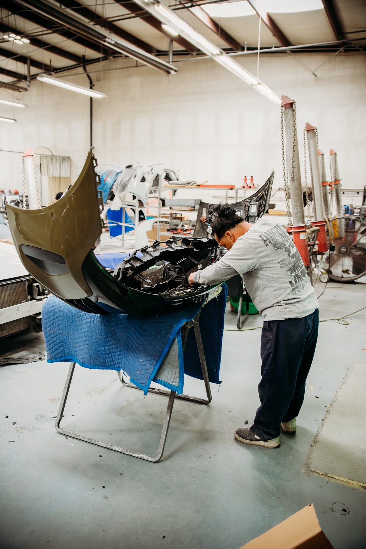 Crazy Color technician assembling a vehicle bumper